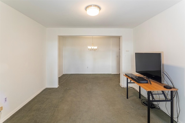 interior space featuring baseboards, carpet flooring, and an inviting chandelier