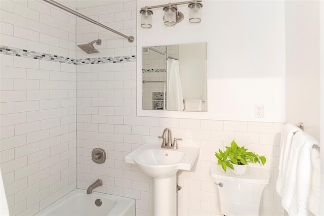 bathroom featuring shower / tub combo and toilet