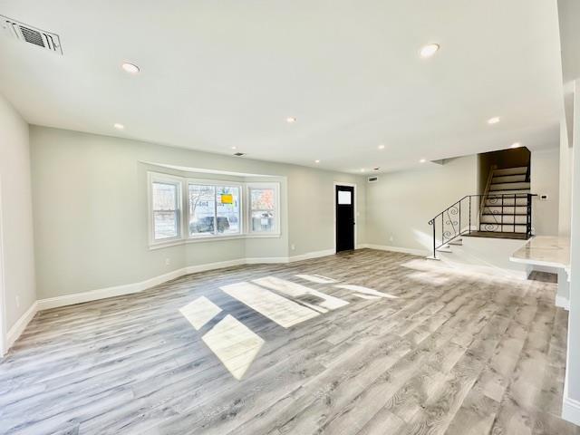 unfurnished living room with light hardwood / wood-style flooring