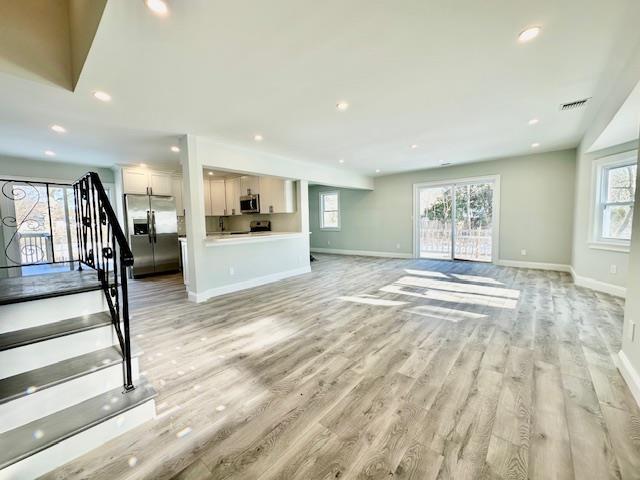 unfurnished living room with light wood-type flooring