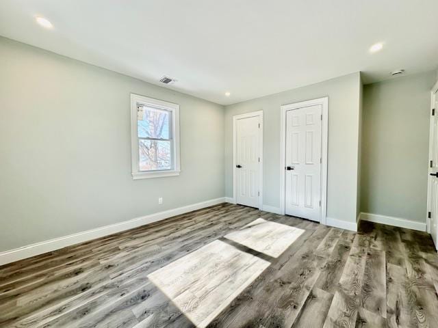 unfurnished bedroom with hardwood / wood-style flooring