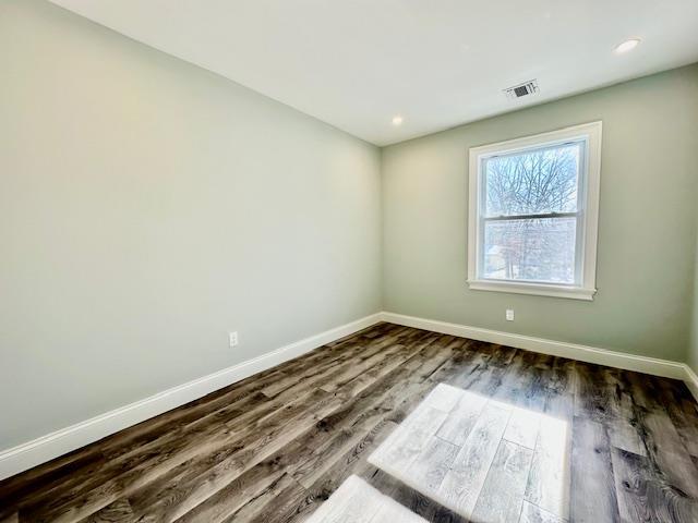 empty room featuring dark wood-type flooring