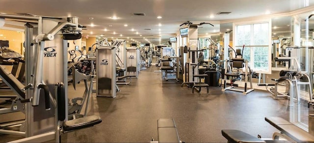 exercise room featuring crown molding