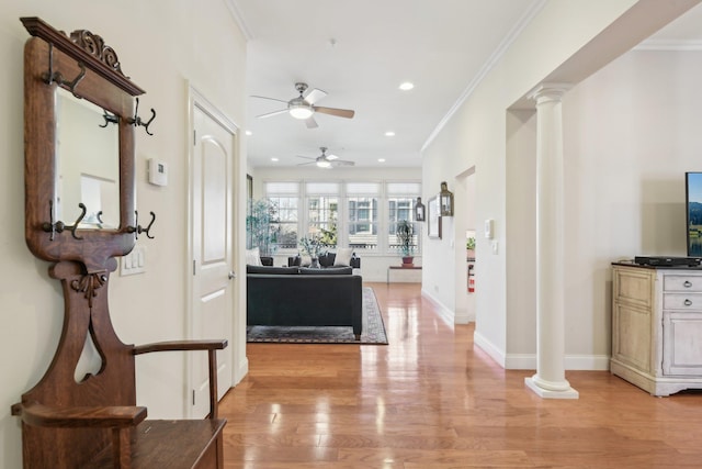 corridor featuring crown molding, decorative columns, and light wood-type flooring