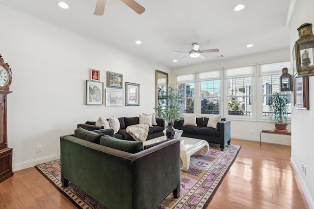 living room with ceiling fan, ornamental molding, and light hardwood / wood-style floors