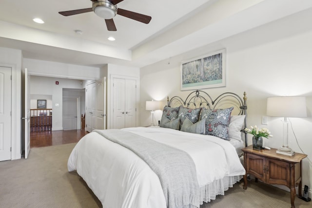 carpeted bedroom featuring ceiling fan and a closet