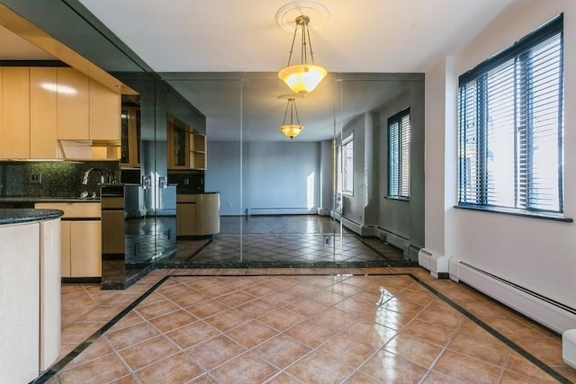 kitchen featuring hanging light fixtures, tasteful backsplash, tile patterned flooring, and a baseboard radiator