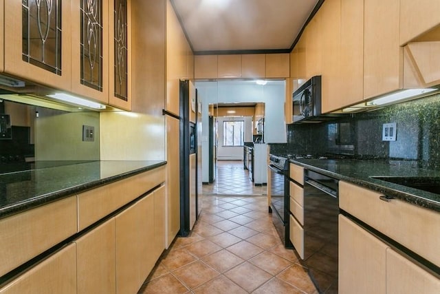 kitchen featuring light tile patterned floors, tasteful backsplash, black appliances, dark stone counters, and light brown cabinets