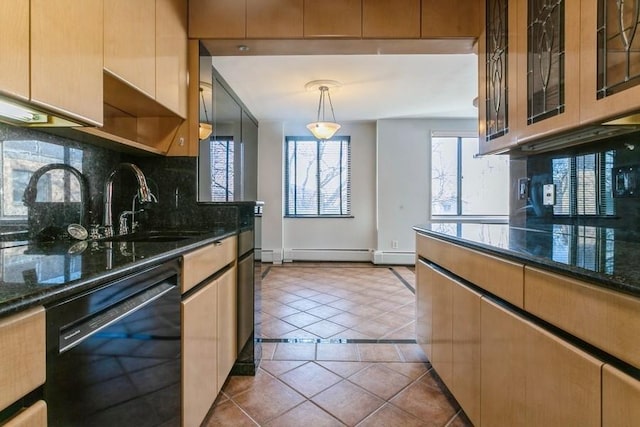 kitchen with dishwasher, pendant lighting, dark stone countertops, and light tile patterned flooring