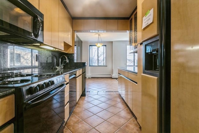 kitchen with sink, baseboard heating, pendant lighting, decorative backsplash, and black appliances