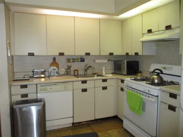 kitchen with sink, decorative backsplash, white appliances, and range hood