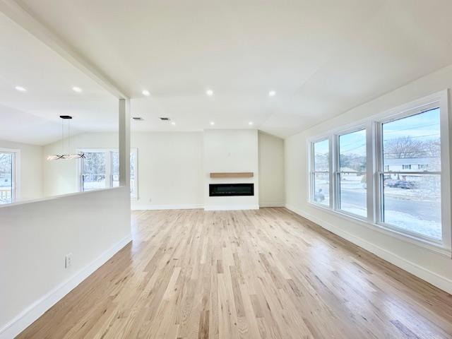 unfurnished living room with light hardwood / wood-style flooring