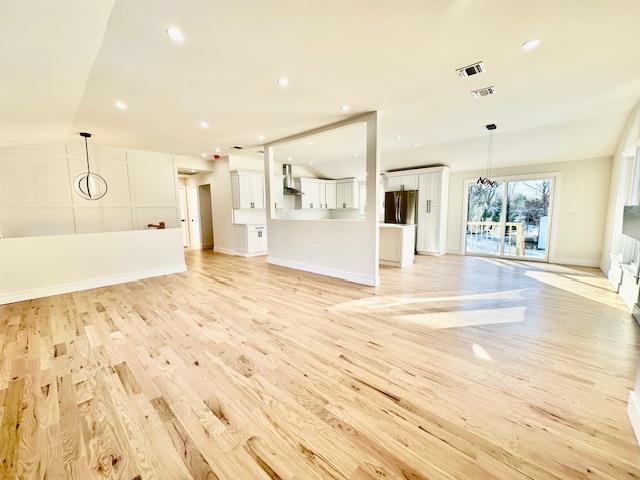 unfurnished living room with light hardwood / wood-style floors