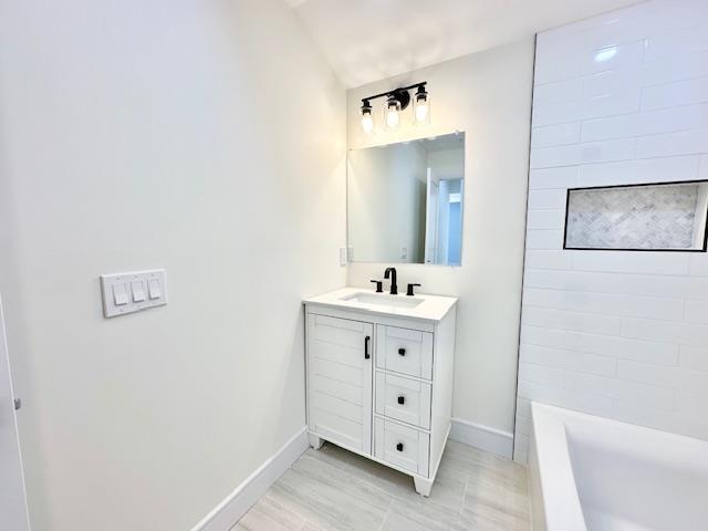 bathroom featuring vanity and shower / tub combination