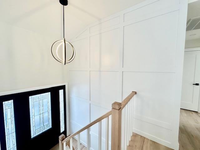 entryway with light hardwood / wood-style flooring and vaulted ceiling