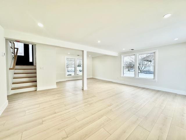 basement with light hardwood / wood-style floors