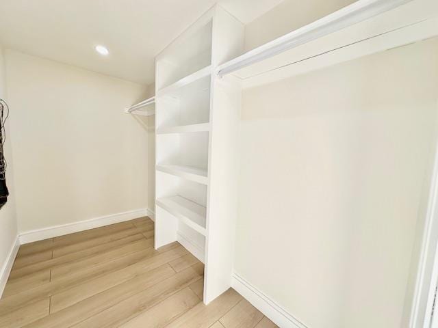 walk in closet featuring hardwood / wood-style flooring