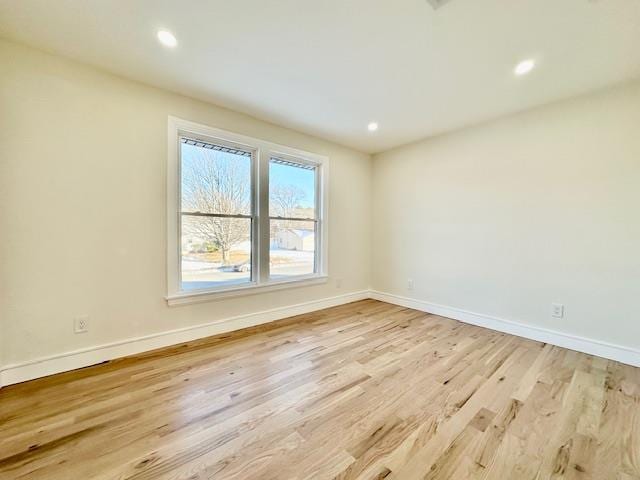 unfurnished room with light hardwood / wood-style flooring