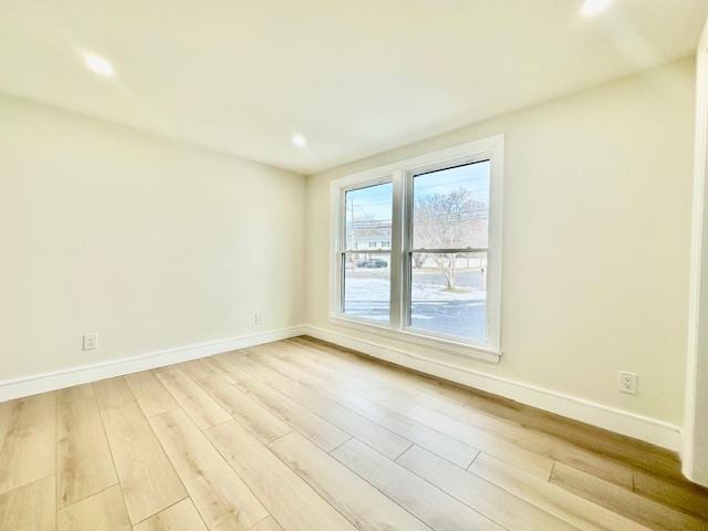 spare room featuring light hardwood / wood-style flooring