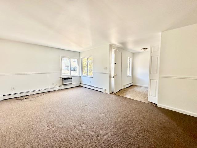 unfurnished living room featuring a baseboard radiator and light carpet