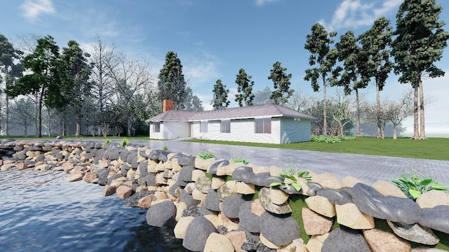 ranch-style home with a chimney and a front yard