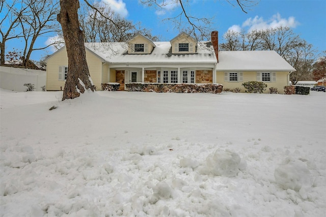 view of snow covered rear of property