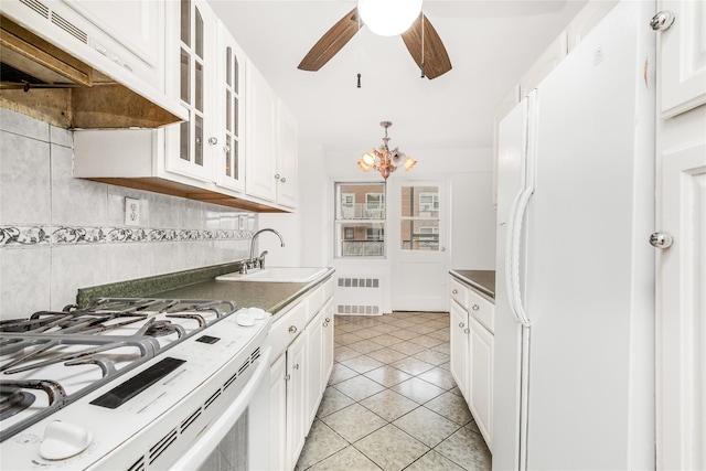 kitchen with white appliances, sink, and white cabinets