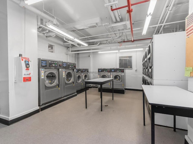 clothes washing area with stacked washer / drying machine and washer and clothes dryer