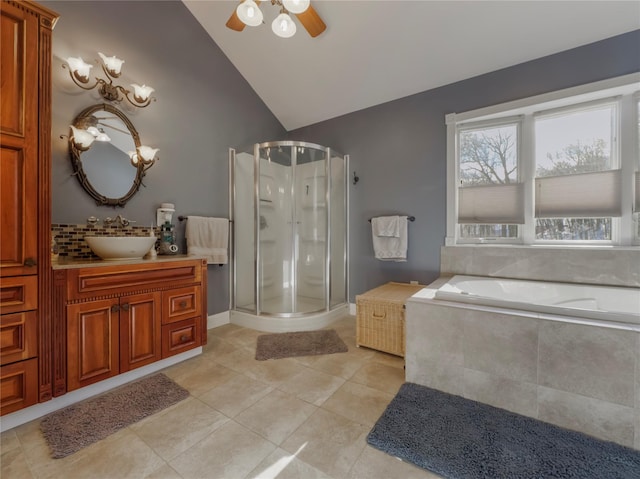 bathroom featuring lofted ceiling, ceiling fan, tile patterned flooring, vanity, and separate shower and tub