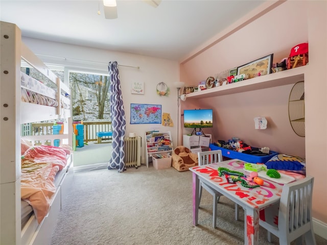 game room featuring ceiling fan, radiator heating unit, and carpet floors