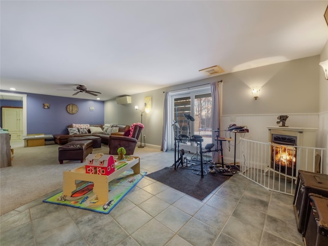 game room featuring a wall mounted air conditioner, ceiling fan, and light tile patterned flooring