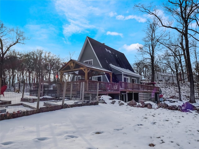 snow covered property featuring a wooden deck