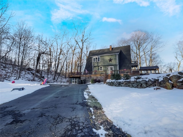 snow covered property with a deck