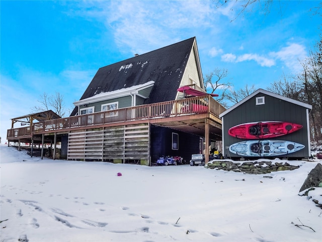 snow covered house with a deck