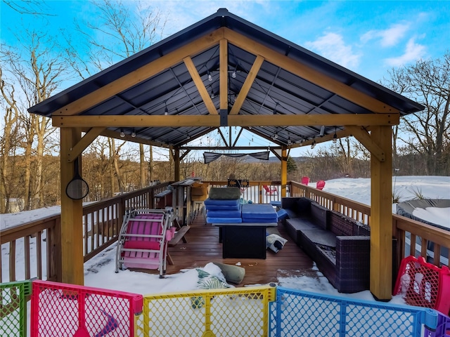 snow covered deck featuring an outdoor living space and a gazebo