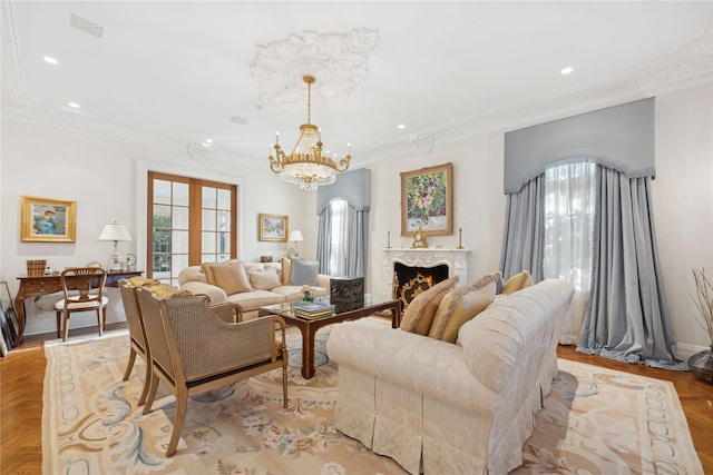 living room with french doors, light parquet flooring, crown molding, and plenty of natural light