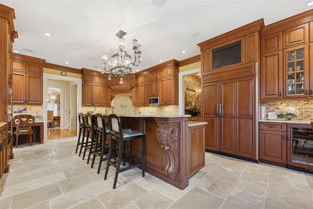 kitchen featuring light stone counters, decorative light fixtures, a chandelier, a center island, and paneled fridge