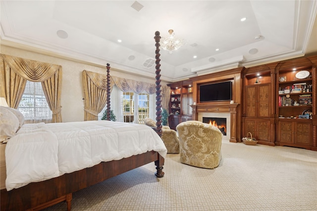 carpeted bedroom featuring ornamental molding and a tray ceiling