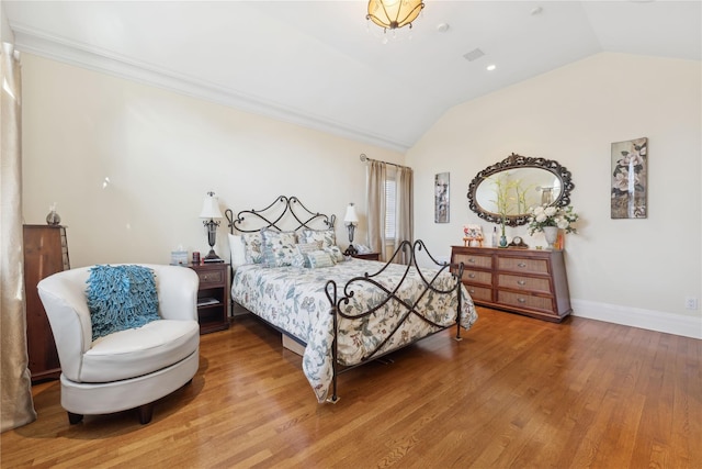 bedroom featuring hardwood / wood-style flooring and vaulted ceiling