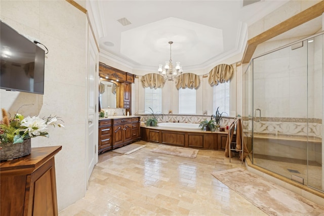 bathroom with plus walk in shower, an inviting chandelier, vanity, and crown molding