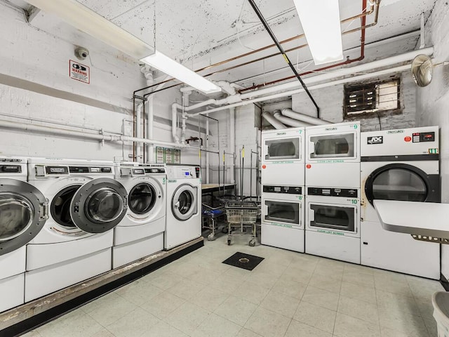 laundry area featuring stacked washer / dryer and washing machine and clothes dryer