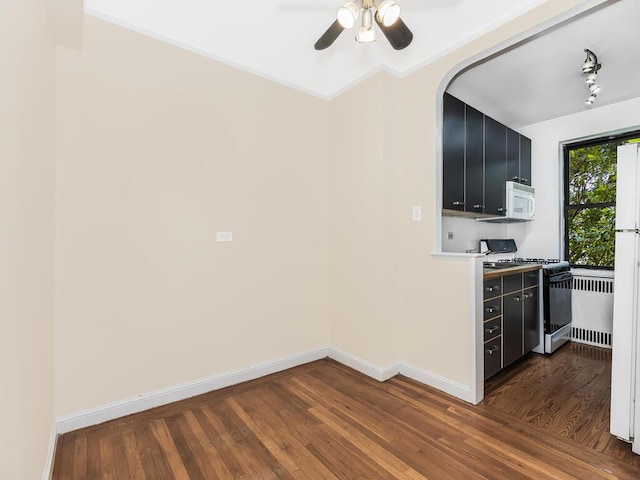 kitchen featuring dark wood-type flooring, white appliances, and ceiling fan