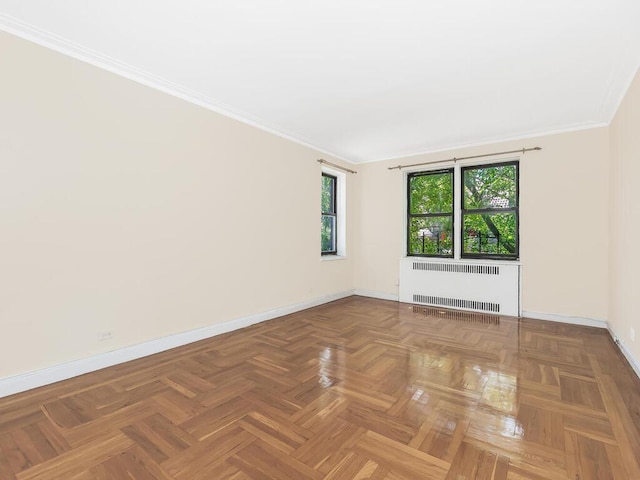 unfurnished room with ornamental molding, radiator heating unit, and parquet floors