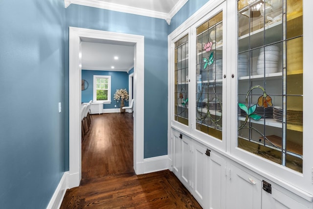 hall featuring ornamental molding and dark hardwood / wood-style floors