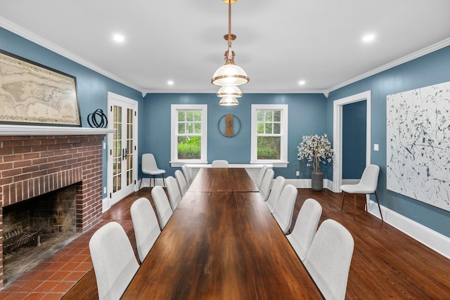 dining room with french doors, a fireplace, ornamental molding, and dark hardwood / wood-style floors