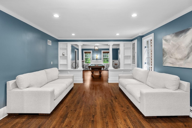 living room featuring decorative columns, dark hardwood / wood-style flooring, and built in shelves