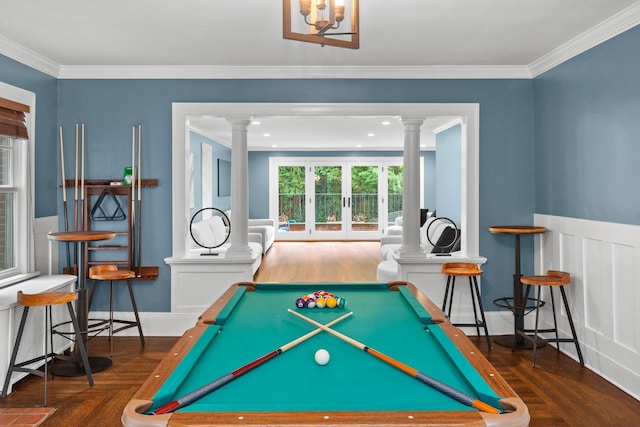 game room with crown molding, dark wood-type flooring, decorative columns, and french doors