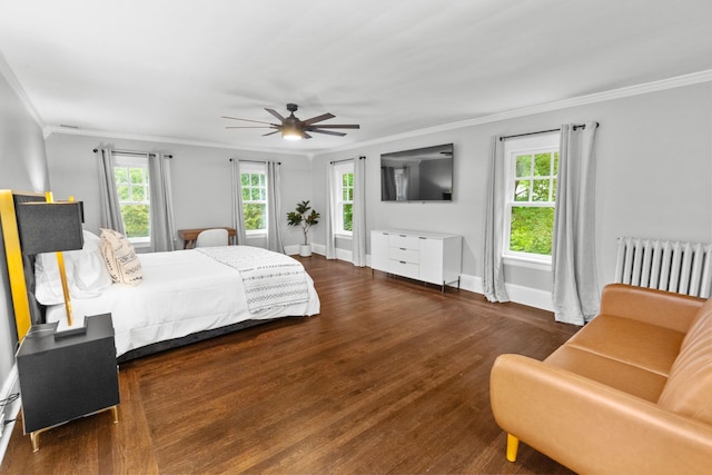 bedroom featuring ornamental molding, radiator heating unit, dark hardwood / wood-style flooring, and multiple windows