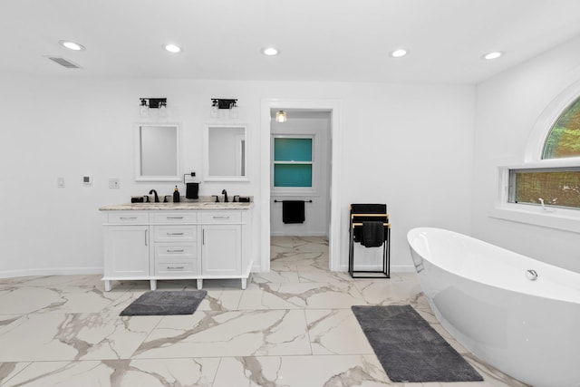 bathroom with vanity and a bathtub