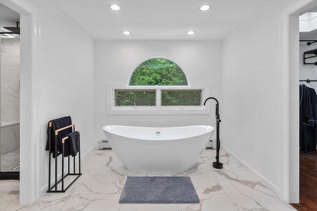 bathroom featuring a baseboard radiator and separate shower and tub